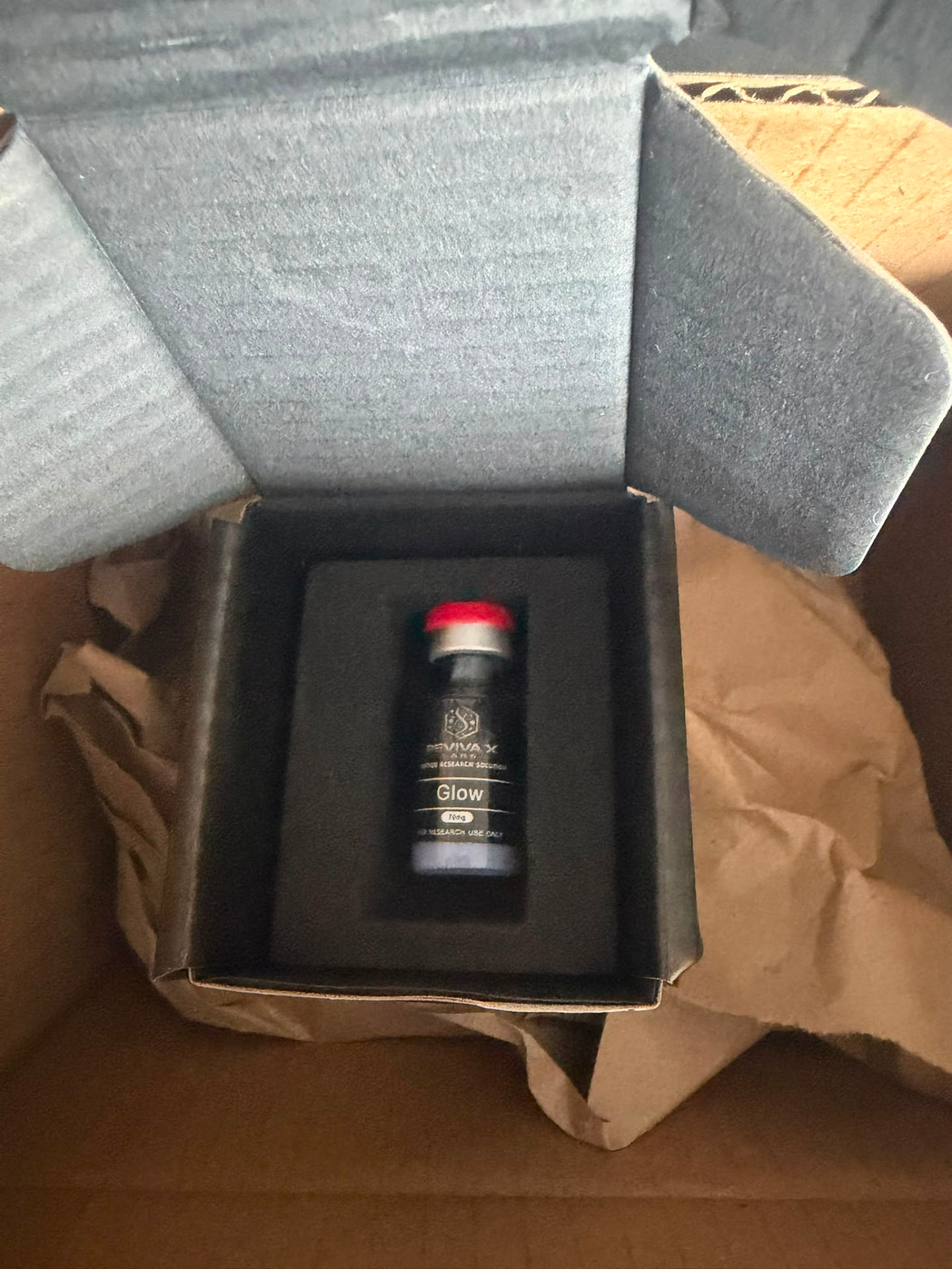 Reviva X Labs Glow research vial in its opened presentation box